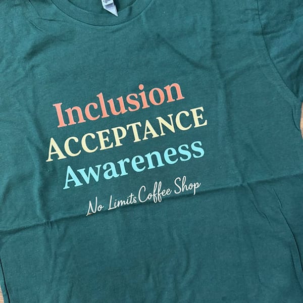 Dark green t-shirt with "Inclusion, Acceptance, Awareness" and "No Limits Coffee Shop" in colorful text.